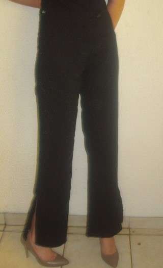 BOOTLEG BLACK PANTS WITH SILVER SPECKS AND SLIDS AT BOTTOM . SIZE 34. CONDITION VERY GOOD