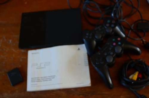 PLAYSTATION 2 WITH 2 CONTROLLERS ONE MEMORY CARD AND 21 GAME'S