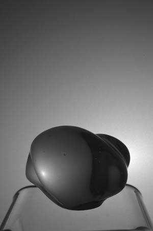 AN IMPORTED FRENCH `ESCARGOT` PAPER WEIGHT MADE FROM CLEAR GLASS