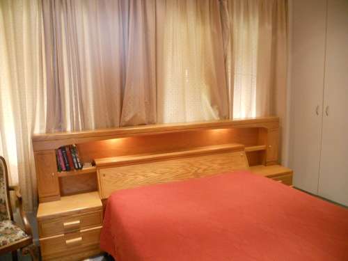 Large Oak Headboard for queen size bed with two bedside tables and a compartment for beddings.