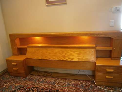 Large Oak Headboard for queen size bed with two bedside tables and a compartment for beddings.