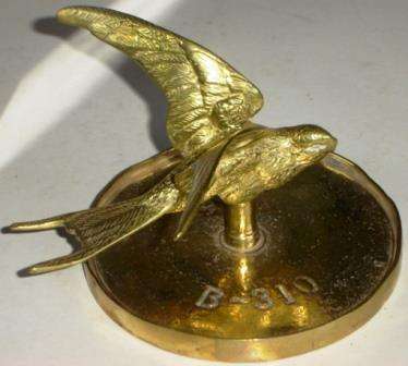 Brass Swallow on a plate with shaft so that the swallow can rotate.