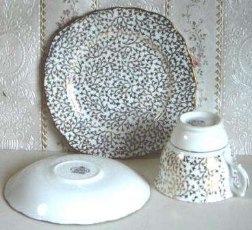 A place setting for five for tea, with Sugar Bowl and Milk Jug.  Crown Regent.