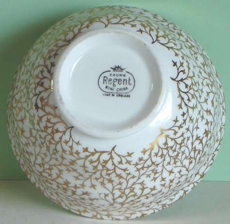 A place setting for five for tea, with Sugar Bowl and Milk Jug.  Crown Regent.