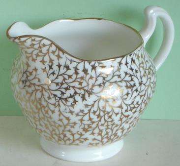 A place setting for five for tea, with Sugar Bowl and Milk Jug.  Crown Regent.
