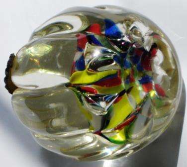An unusual Glass Paper Weight with fluted sides.