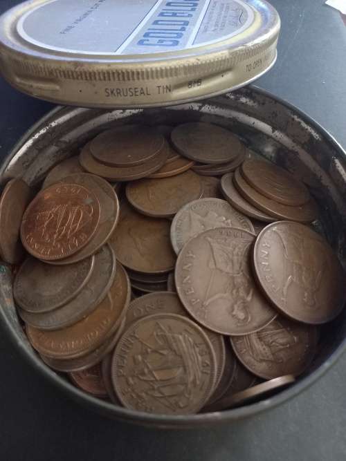 Tin with over 60 Great Britain pennies and half pennies