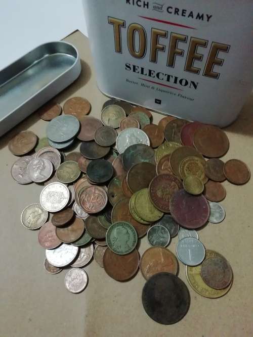Toffee tin with mixed 120 international coins