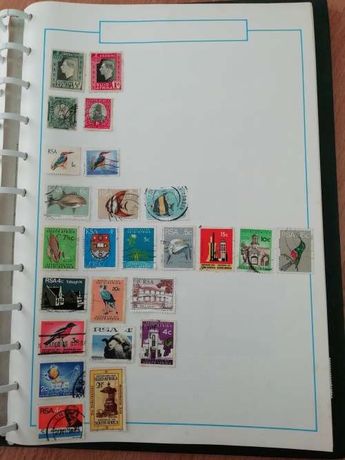 Stamp album, full of hinged stamps.