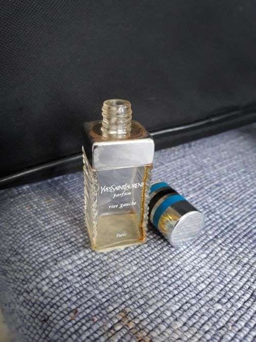 A YVES SAINT LAURENT PERFUME BOTTLE.