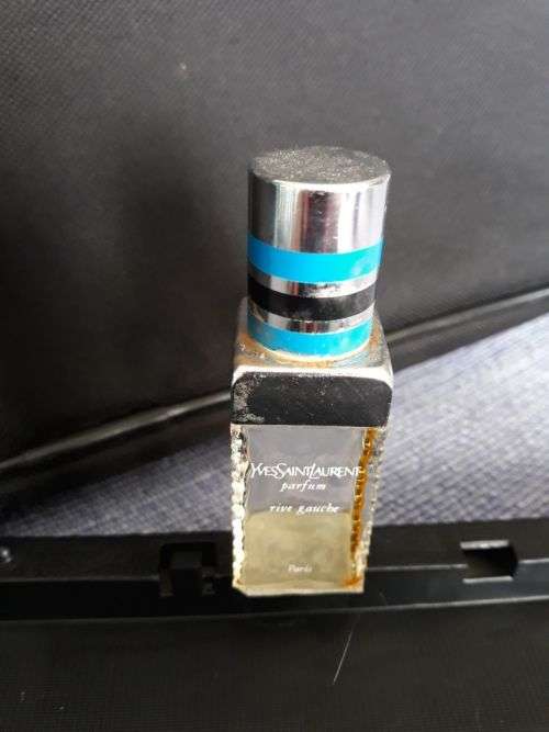 A YVES SAINT LAURENT PERFUME BOTTLE.