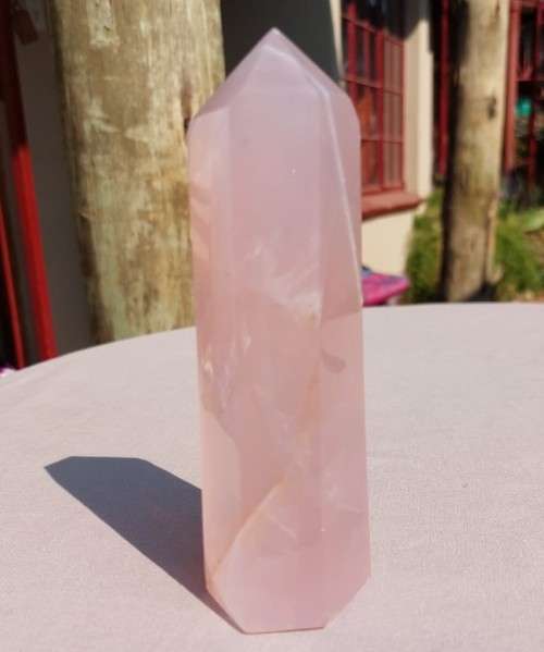 A 400G ROSE QUARTZ OBELISK WITH A 6 FACETTED POINT  CUT AND POLISHED IN ZAMBIA
