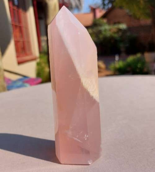 A 400G ROSE QUARTZ OBELISK WITH A 6 FACETTED POINT  CUT AND POLISHED IN ZAMBIA