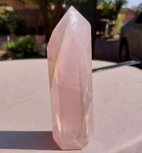 A 400G ROSE QUARTZ OBELISK WITH A 6 FACETTED POINT  CUT AND POLISHED IN ZAMBIA