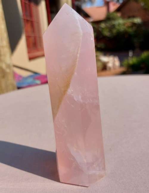 A 400G ROSE QUARTZ OBELISK WITH A 6 FACETTED POINT  CUT AND POLISHED IN ZAMBIA