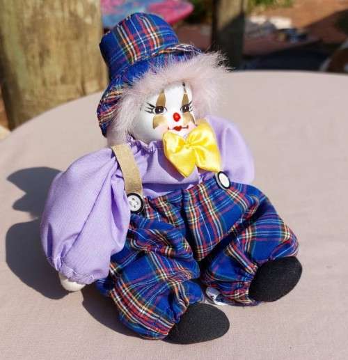CREEPY CLOWN DOLL WITH PLASTIC FACE AND SAWDUST FILLED BODY