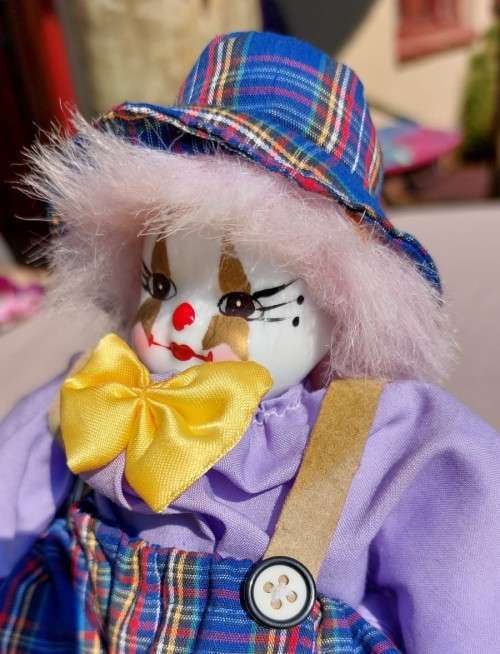 CREEPY CLOWN DOLL WITH PLASTIC FACE AND SAWDUST FILLED BODY