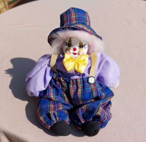 CREEPY CLOWN DOLL WITH PLASTIC FACE AND SAWDUST FILLED BODY