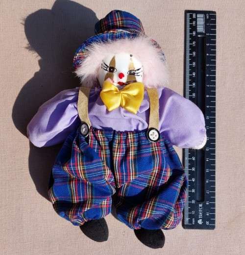 CREEPY CLOWN DOLL WITH PLASTIC FACE AND SAWDUST FILLED BODY