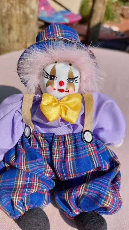 CREEPY CLOWN DOLL WITH PLASTIC FACE AND SAWDUST FILLED BODY