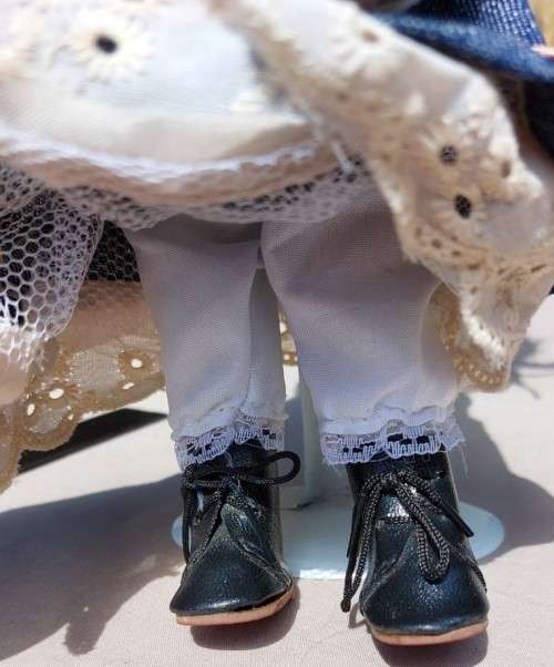 CUTE HIGH QUALITY PORCELAIN DOLL WITH BLUE EYES AND BIG EYELASHES ON STAND