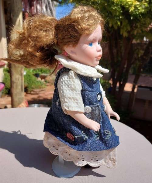 CUTE HIGH QUALITY PORCELAIN DOLL WITH BLUE EYES AND BIG EYELASHES ON STAND