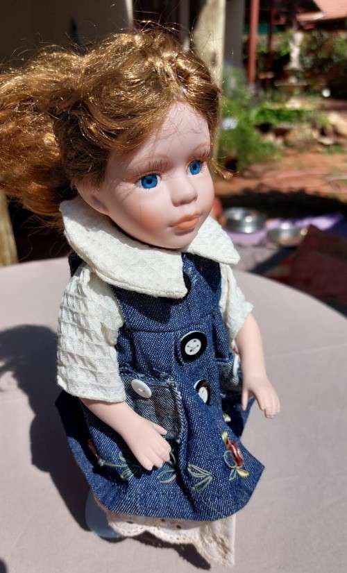 CUTE HIGH QUALITY PORCELAIN DOLL WITH BLUE EYES AND BIG EYELASHES ON STAND