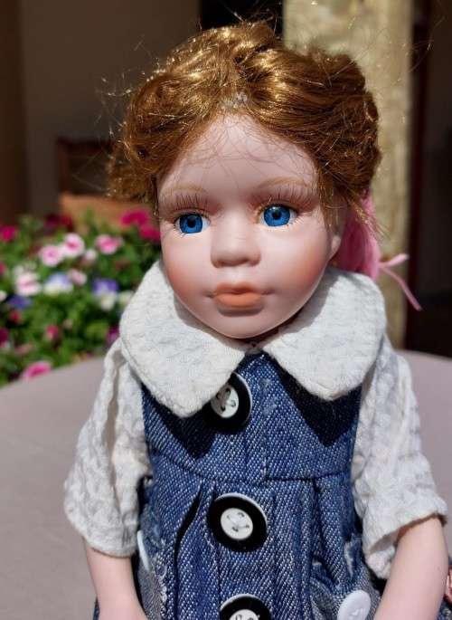 CUTE HIGH QUALITY PORCELAIN DOLL WITH BLUE EYES AND BIG EYELASHES ON STAND