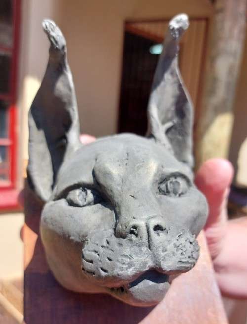 CARACAL (ROOIKAT) HENKMAM CLAY SCULPTURE WITH BRONZE COATING ON WOODEN WALL MOUNT