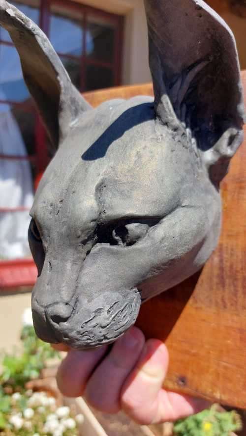 CARACAL (ROOIKAT) HENKMAM CLAY SCULPTURE WITH BRONZE COATING ON WOODEN WALL MOUNT