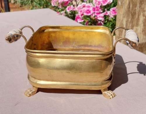 1940S BRASS AND METAL PLANTER WITH DELFT CERAMIC HANDLES AND CLAW FEET