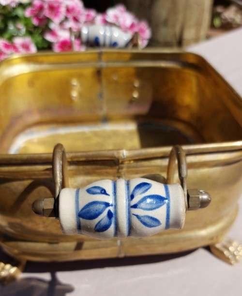 1940S BRASS AND METAL PLANTER WITH DELFT CERAMIC HANDLES AND CLAW FEET