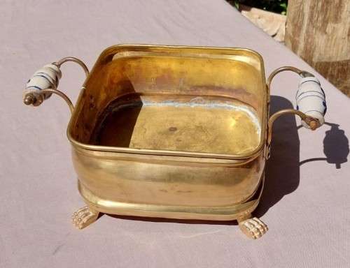 1940S BRASS AND METAL PLANTER WITH DELFT CERAMIC HANDLES AND CLAW FEET