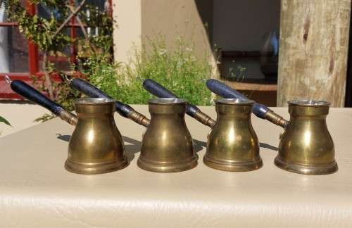 FOUR TURKISH OR GREEK OR ARABIC BRASS COFFEE POTS (CEZVES OR BRIKIS OR JADWHAS)