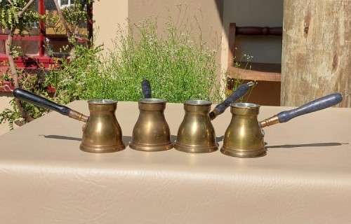 FOUR TURKISH OR GREEK OR ARABIC BRASS COFFEE POTS (CEZVES OR BRIKIS OR JADWHAS)