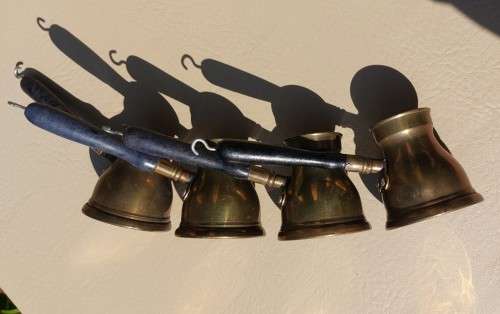 FOUR TURKISH OR GREEK OR ARABIC BRASS COFFEE POTS (CEZVES OR BRIKIS OR JADWHAS)