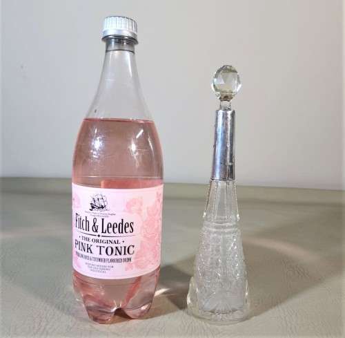 A 1910 DAVID LOEBL SCHINDLER and CO STERLING SILVER COLLAR ON A TALL CYLINDRICAL GLASS SCENT BOTTLE