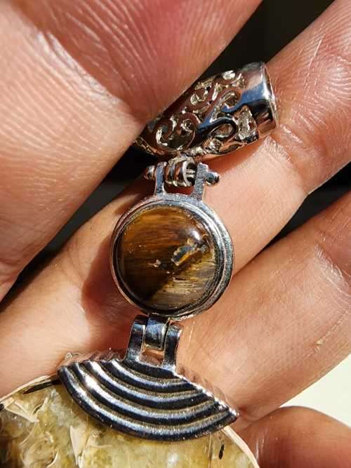 POLISHED AMMONITE FOSSIL WITH A PROTECTIVE TIGER EYE GEMSTONE PENDANT