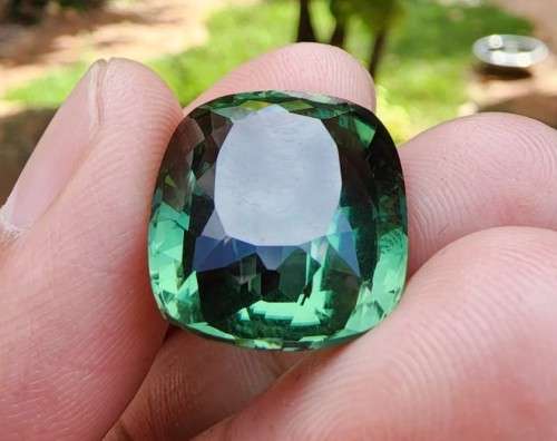 A LARGE MANMADE 24.34CARAT GREEN AMETHYST GEMSTONE WITH BEAUTIFUL CUSHION CUT