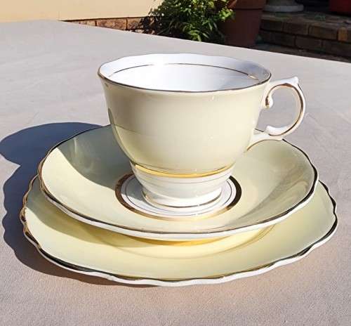 A WW2 ERA 1939 MARKED COLCOUGH CHINA TRIO IN HARLEQUIN BALLET LEMON YELLOW PATTERN (1ST OF 6)