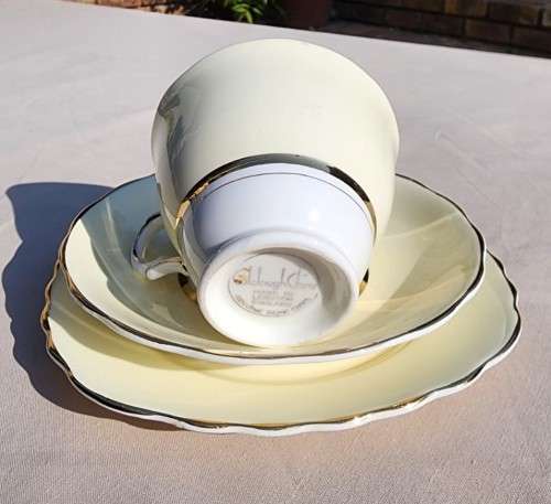 A WW2 ERA 1939 MARKED COLCOUGH CHINA TRIO IN HARLEQUIN BALLET LEMON YELLOW PATTERN (1ST OF 6)