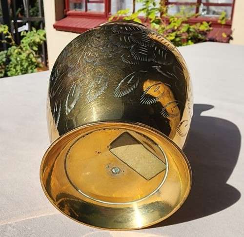 A BRASS VASE WITH LEAVE ENGRAVINGS