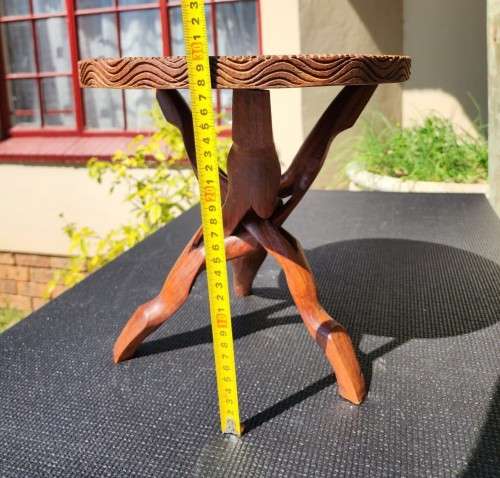 ORIENTAL TEAK COFFEE TABLE  CIRCULAR TOP WITH CARVED FLORAL BORDER AND FOLDING TRIPOD FEET