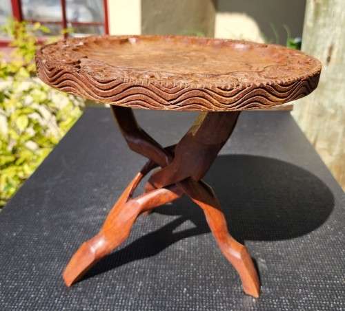 ORIENTAL TEAK COFFEE TABLE  CIRCULAR TOP WITH CARVED FLORAL BORDER AND FOLDING TRIPOD FEET