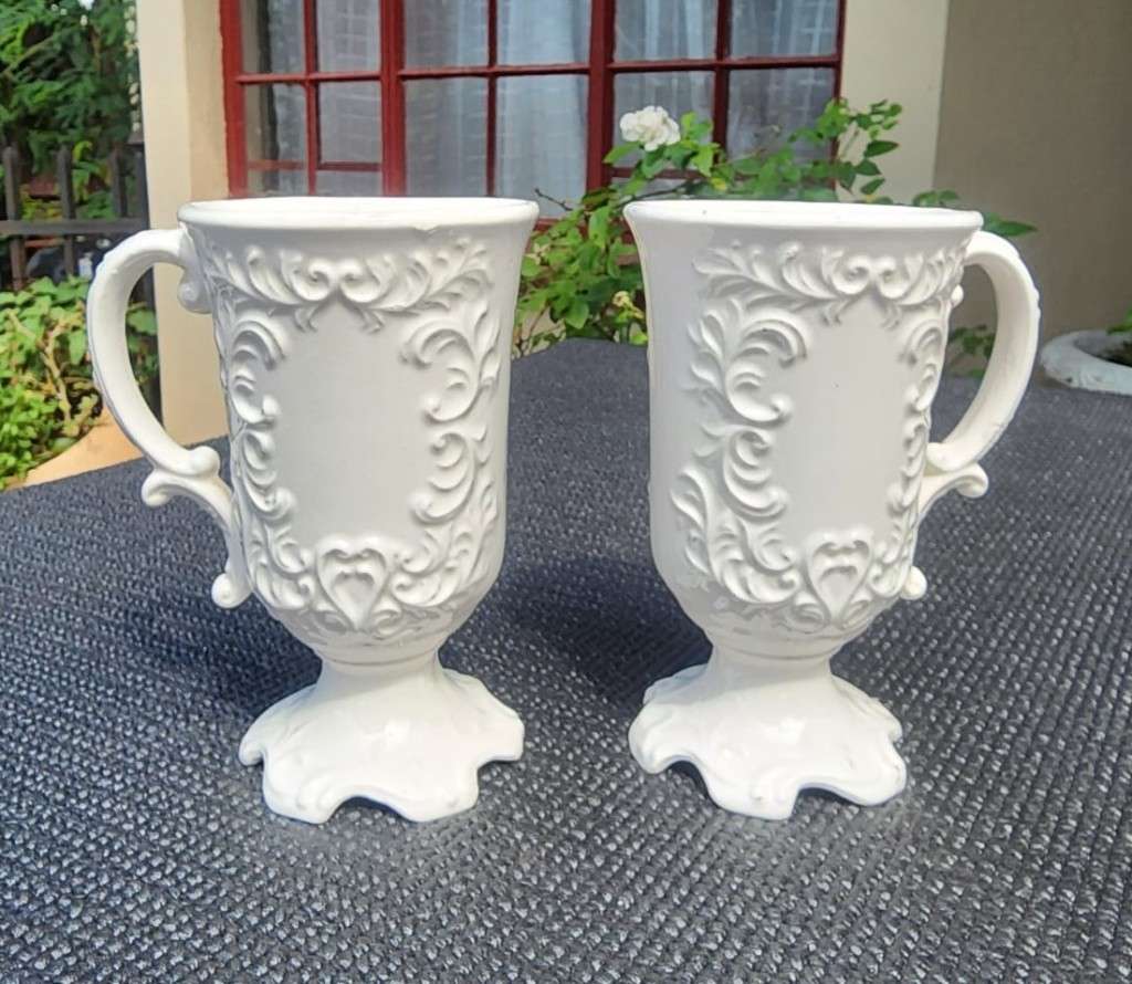 PAIR OF BALBOA HANDMADE CERAMIC CHALICES WITH RAISED FOILAGE AND FLOWER DESIGN