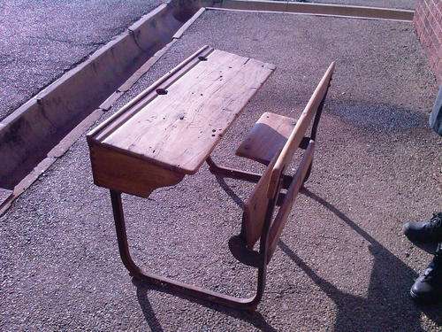 AN EARLY SCHOOL DESK IN OAK