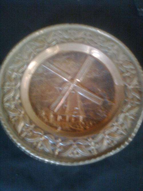 Copper wall plate with picture of a windmill.