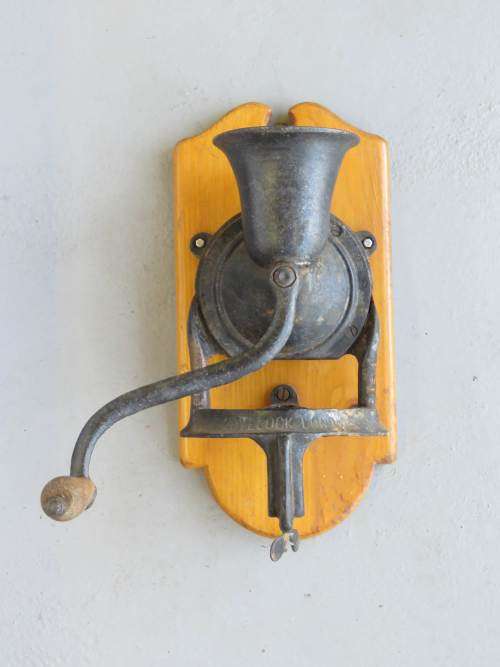 Old Lovelock coffee grinder on wooden plaque - Broken and repaired