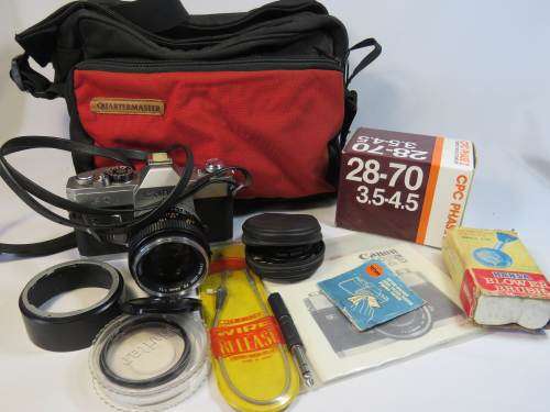 Canon FTb QL camera with 50mm FD lens 1:1.4, booklets, and filter