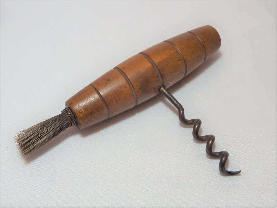 Antique direct pull corkscrew with wooden handle and brush